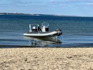 Highfield DL 540 2019 Highfield DL 540 boat anchored near sandy beach with calm blue water.