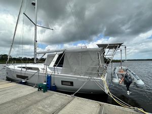 Beneteau Oceanis 46.1 2023 Beneteau Oceanis 46.1 sailboat docked with dinghy, under cloudy sky.