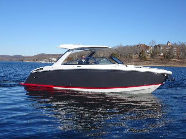 Cobalt R33 2025 Cobalt R33 boat on a lake, sleek design, blue sky background.
