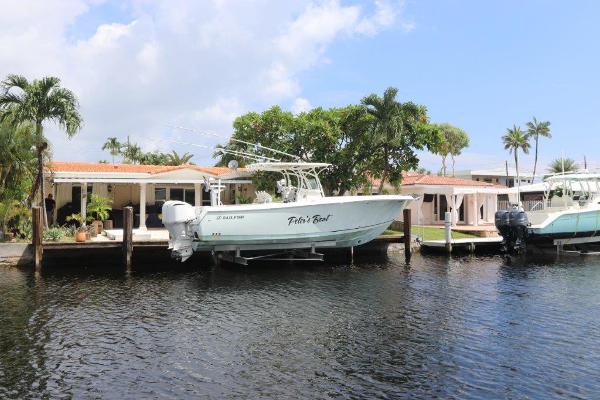 Sailfish 320 CC 2013 Sailfish 320 CC boat docked by waterfront homes.