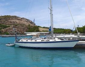 Hallberg-Rassy 42F Mk II Sailboat Hallberg-Rassy 42F Mk II, 1998 model, docked in turquoise waters near rocky shoreline.
