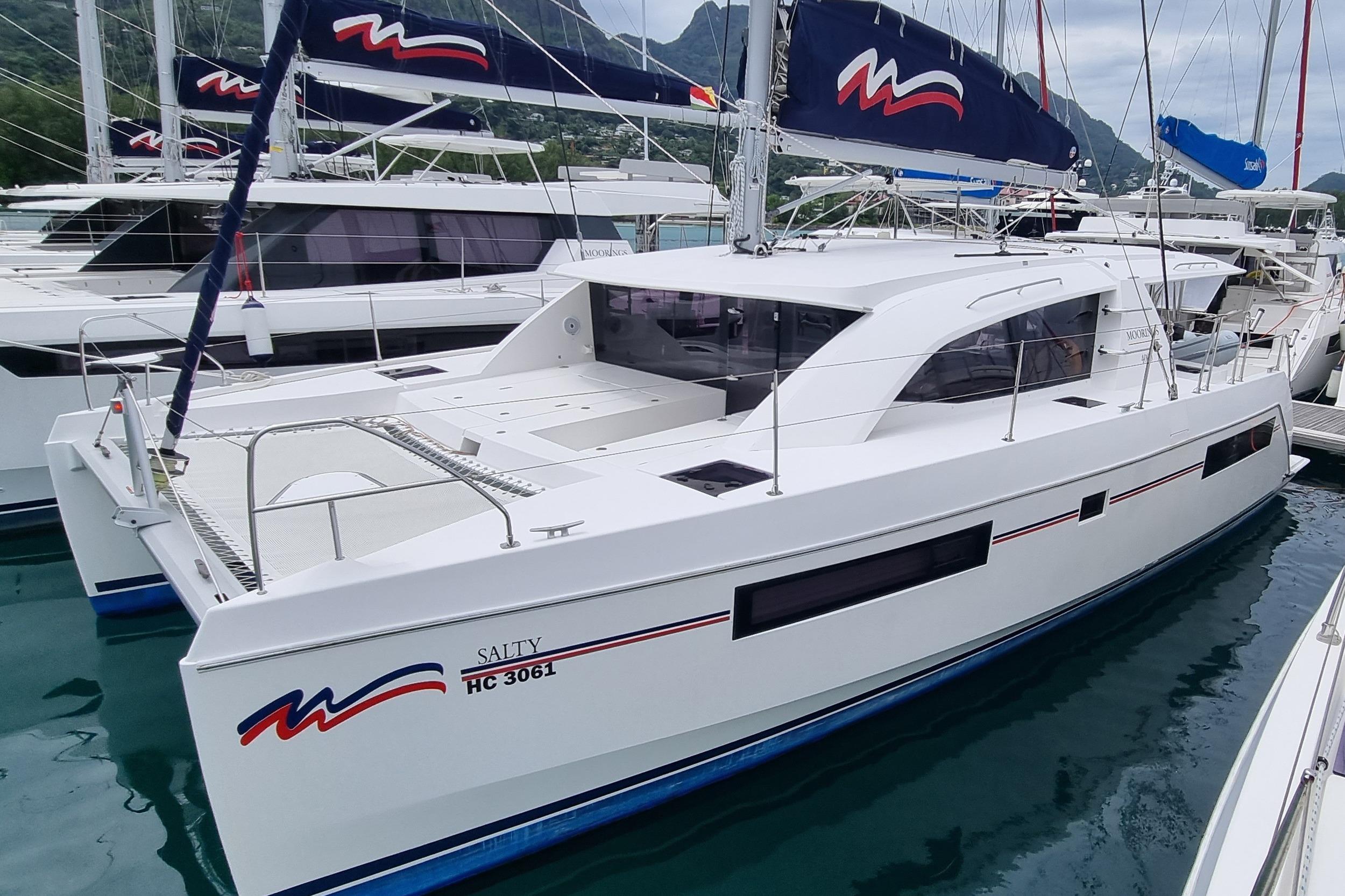 Leopard 40 2020 Leopard 40 catamaran docked in marina, featuring sleek design and modern sails.