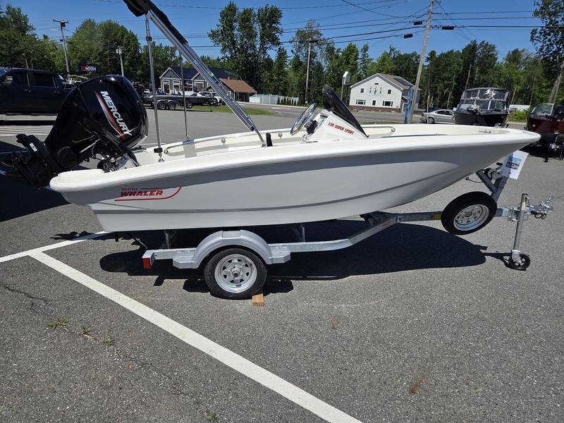 Boston Whaler 130 Super Sport 2025 Boston Whaler 130 Super Sport boat on trailer, parked outdoors.