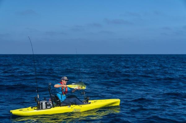 Hobie Mirage Outback Man fishing on 2025 Hobie Mirage Outback kayak in open ocean.
