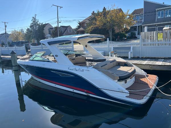 Sea Ray 310 SLX 2018 Sea Ray 310 SLX boat docked by waterfront homes.