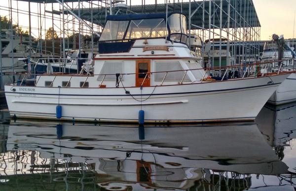 DeFever 41 Trawler 1983 DeFever 41 Trawler docked at marina, reflecting on calm water.