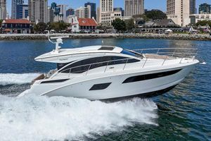 Sea Ray Sundancer 400 2017 Sea Ray Sundancer 400 yacht cruising in a city harbor with skyline backdrop.