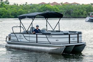 Veranda Relax VR22RFL 2023 Veranda Relax VR22RFL pontoon boat cruising on a scenic lake.