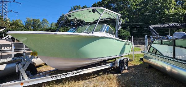 Sea Pro 240 Sport 2025 Sea Pro 240 Sport boat on trailer, light green hull, parked outdoors.