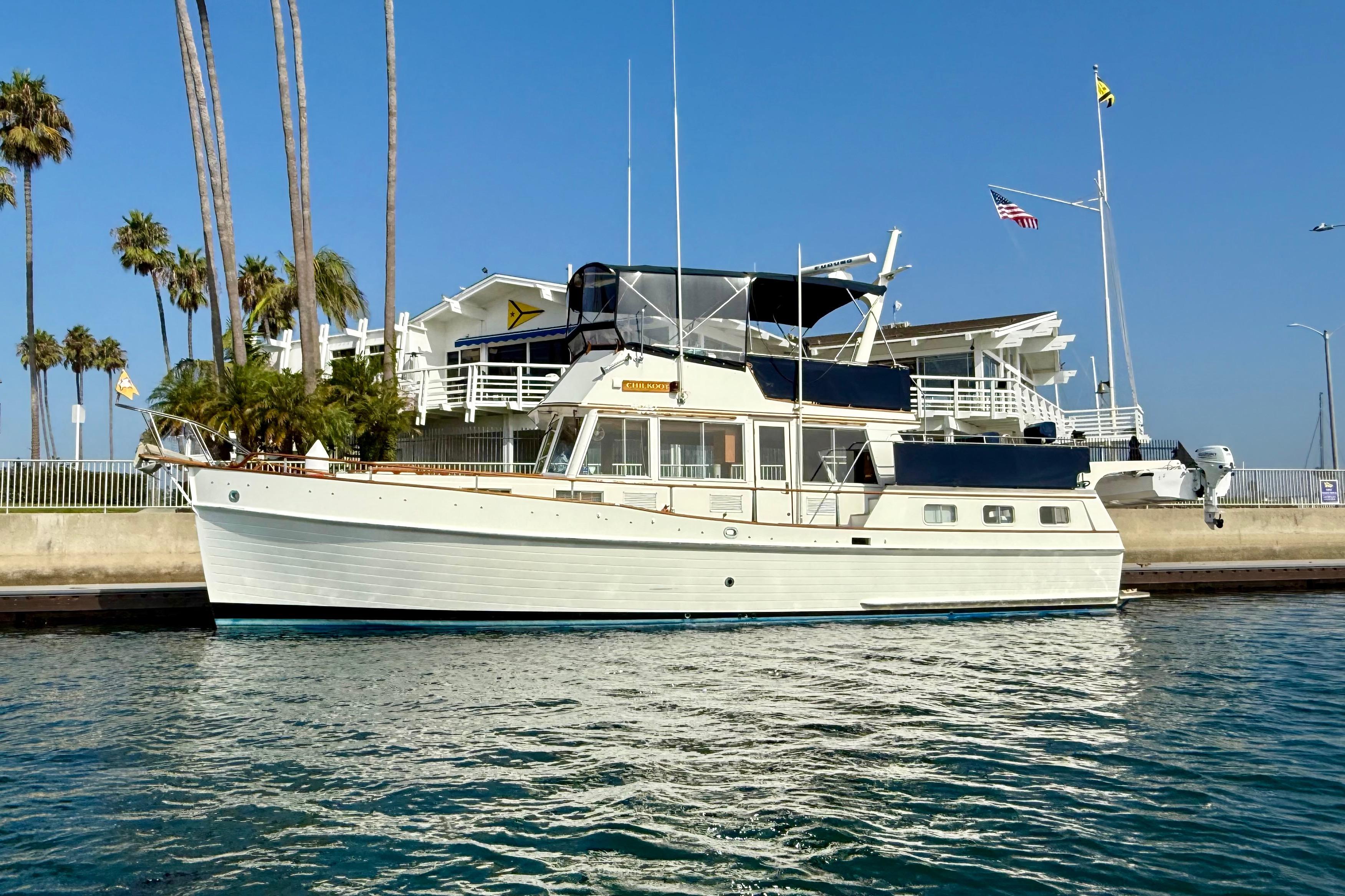 Grand Banks 42 Motoryacht 1982 Grand Banks 42 Motoryacht docked near palm trees and waterfront building.
