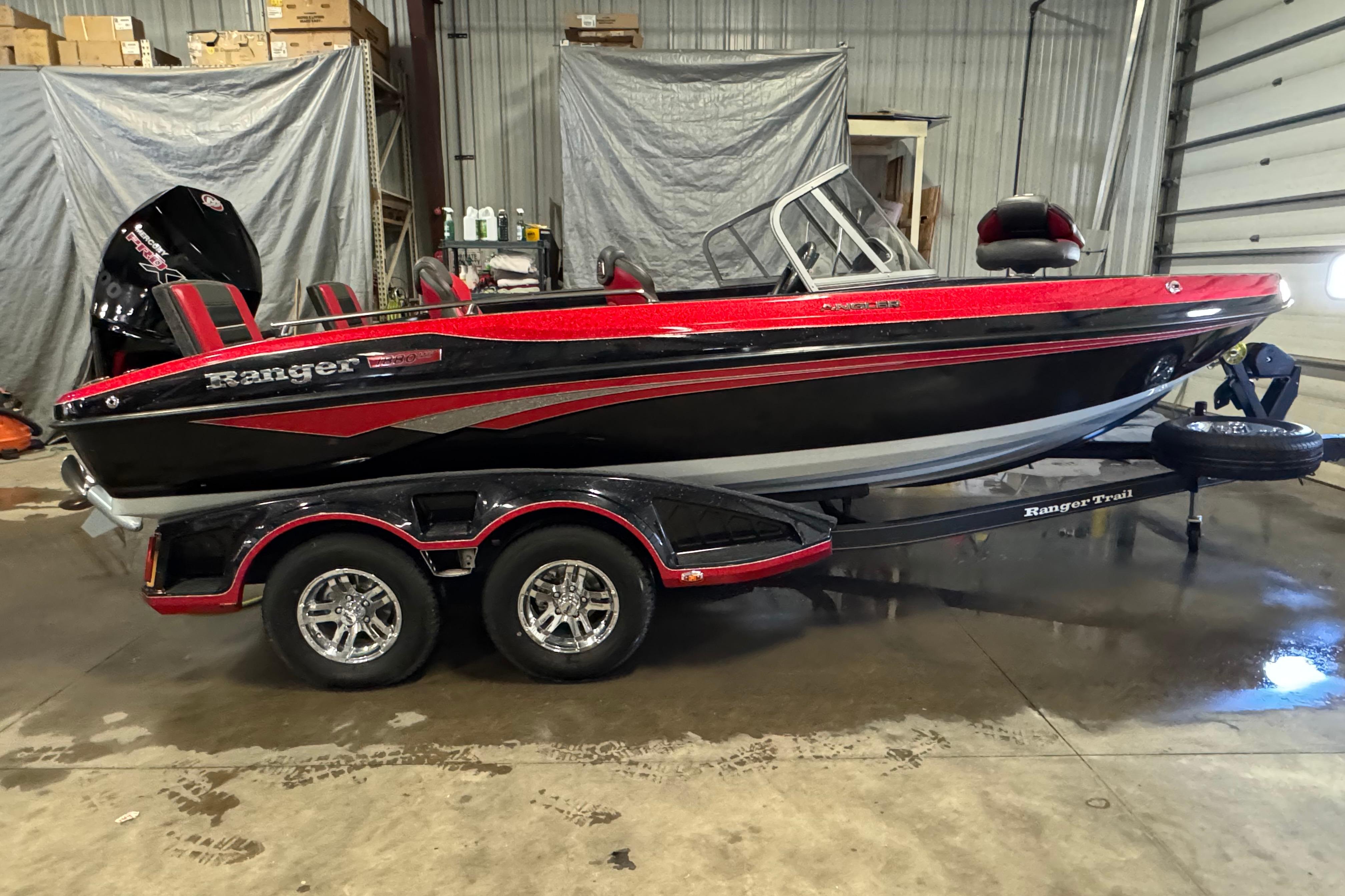 Ranger 1880MS 2023 Ranger 1880MS boat in a garage, featuring a sleek red and black design.