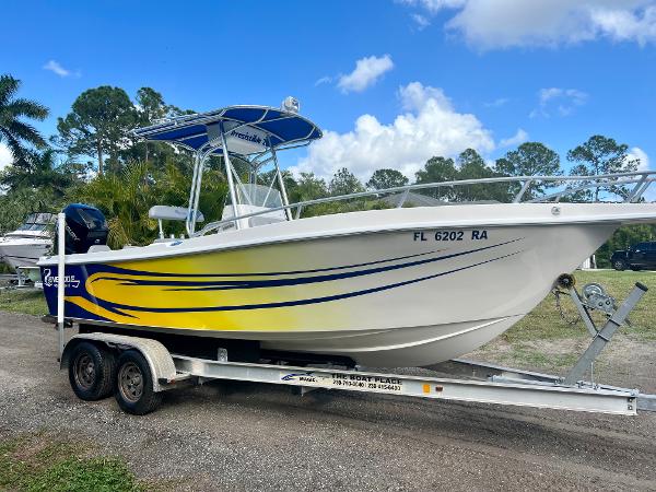 Renegade 250 2016 Renegade 250 boat on a trailer with yellow and blue graphics.