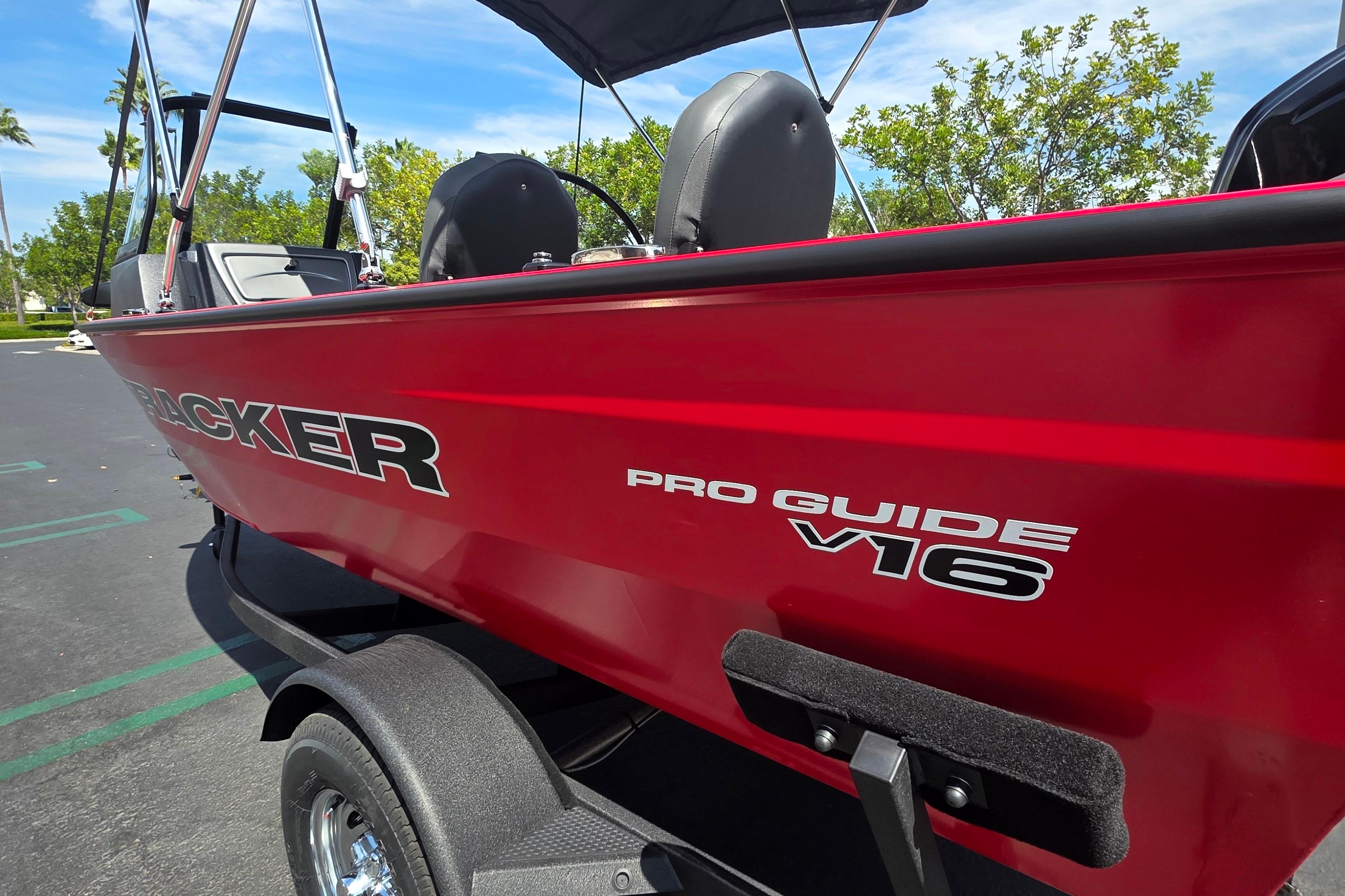 Tracker Pro Guide V-16 WT 2026 Tracker Pro Guide V-16 WT boat, red exterior, parked outdoors.