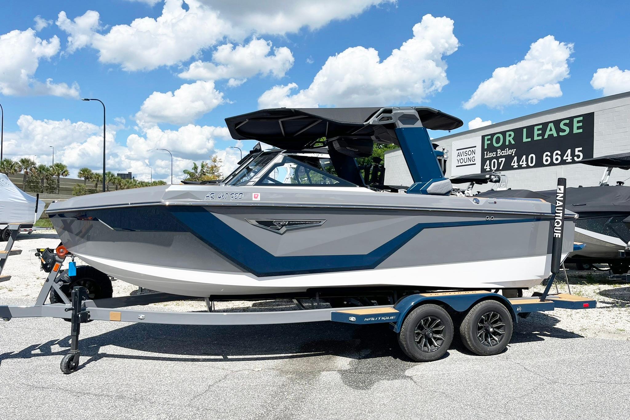 Nautique Super Air Nautique S21 2025 Nautique Super Air Nautique S21 boat on trailer under blue sky.