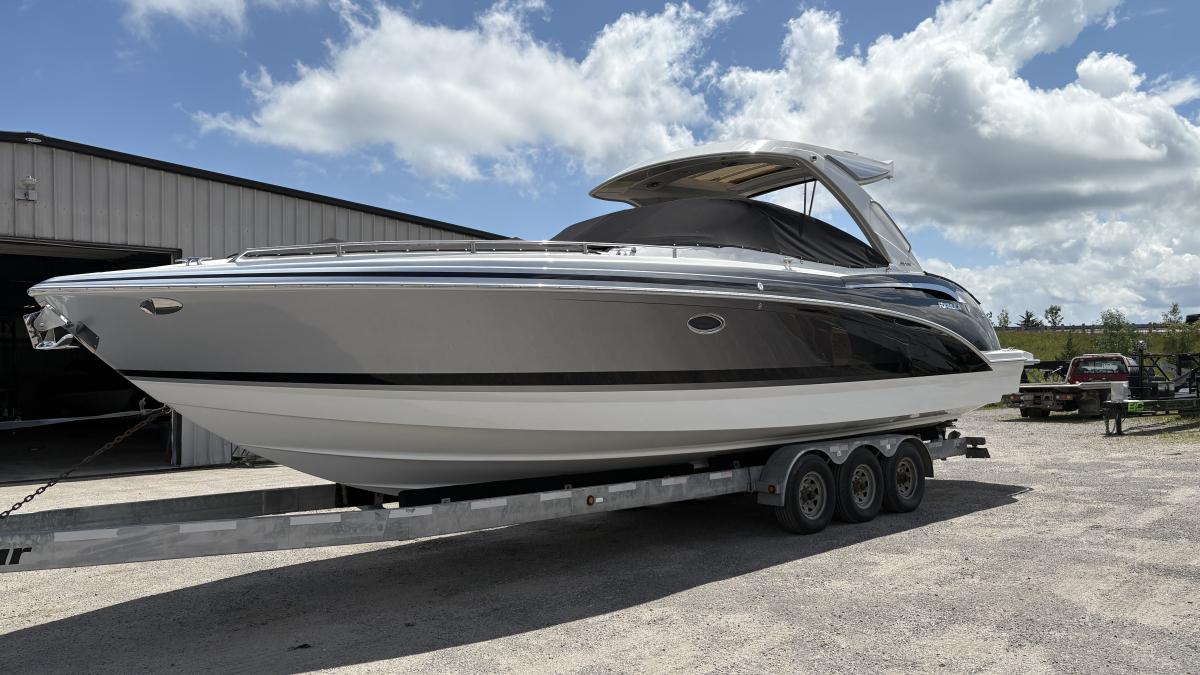 Formula 350 CBR 2022 Formula 350 CBR boat on trailer, parked outdoors under a partly cloudy sky.