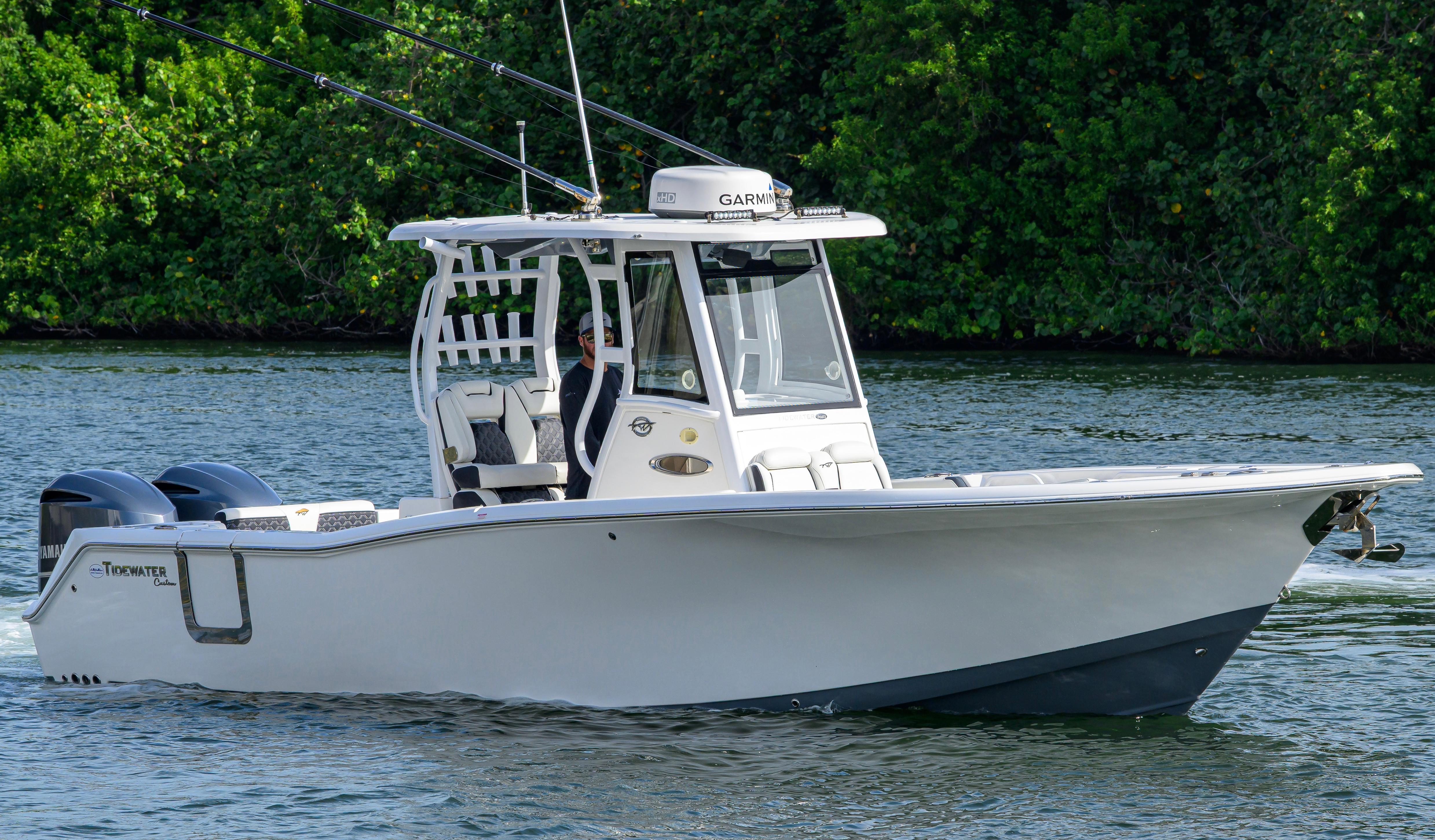 Tidewater 292 CC Adventure 2019 Tidewater 292 CC Adventure boat cruising on a calm river with lush greenery.