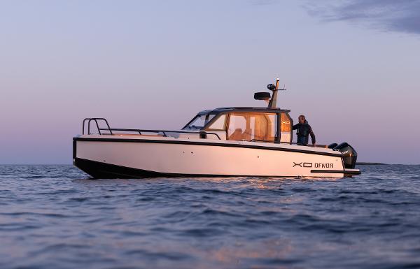 XO Boats DFNDR 9 2024 XO Boats DFNDR 9 cruising on calm waters at sunset.