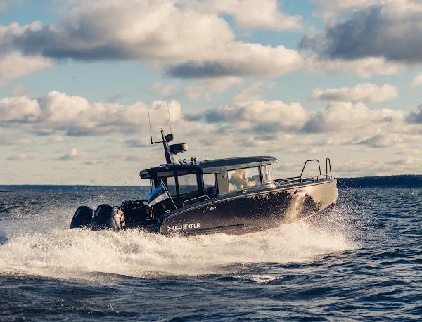 XO Boats EXPLR 10 S Plus 2024 XO Boats EXPLR 10S cruising on open water under a partly cloudy sky.