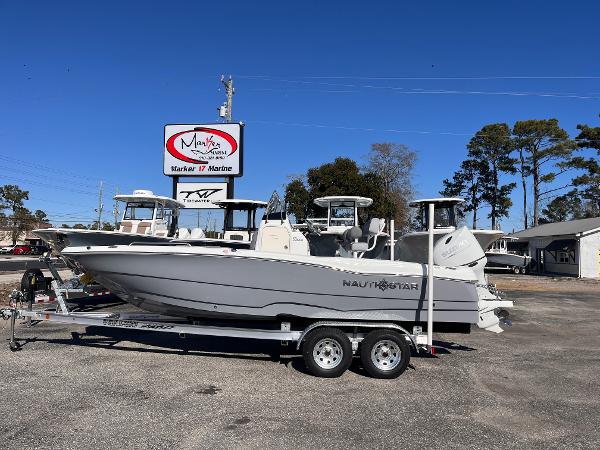 NauticStar 211 Hybrid 2025 NauticStar 211 Hybrid boat on trailer at dealership.