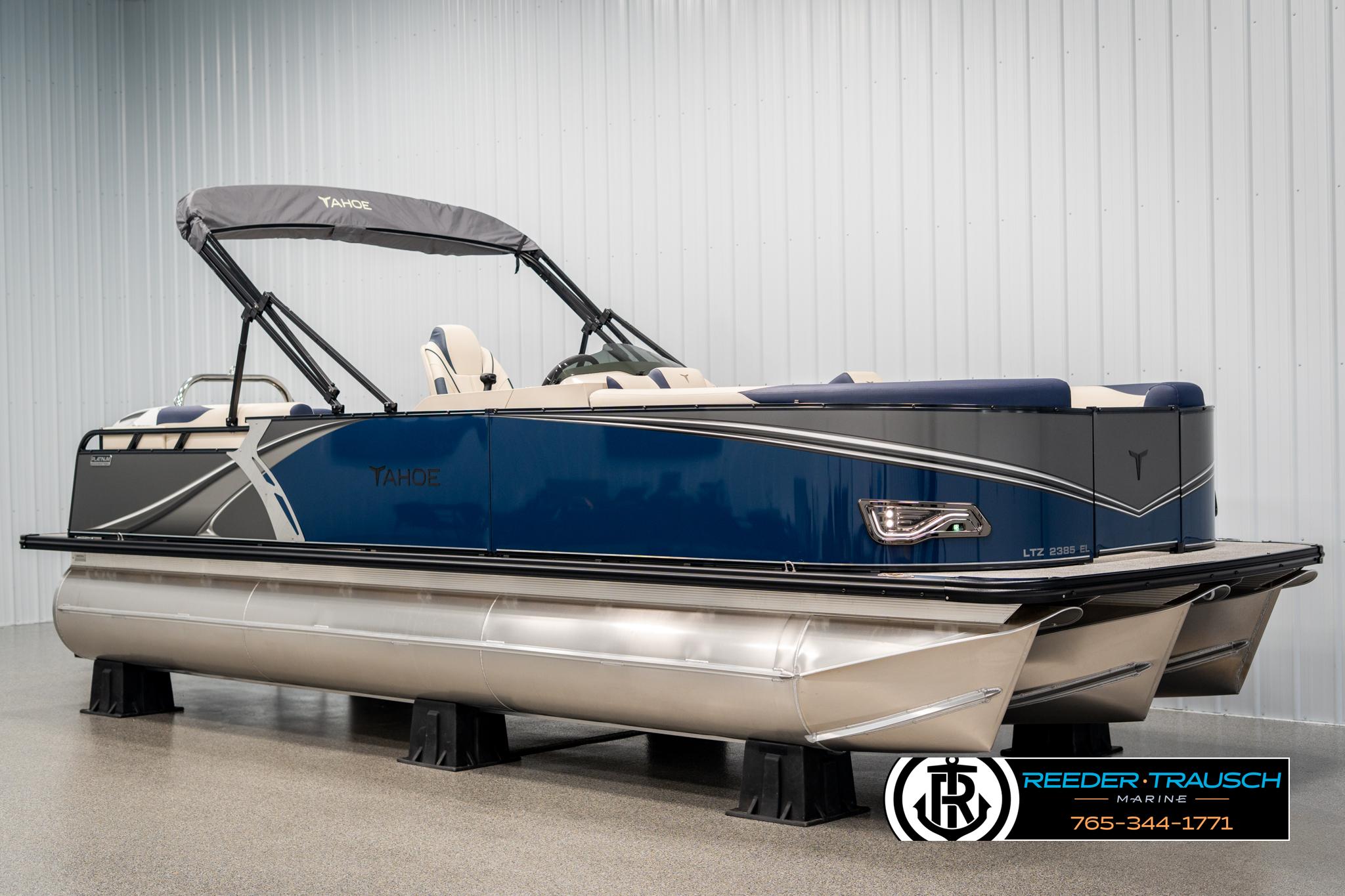 Tahoe LTZ EL 2025 Tahoe LTZ EL pontoon boat in showroom, featuring sleek blue and silver design.