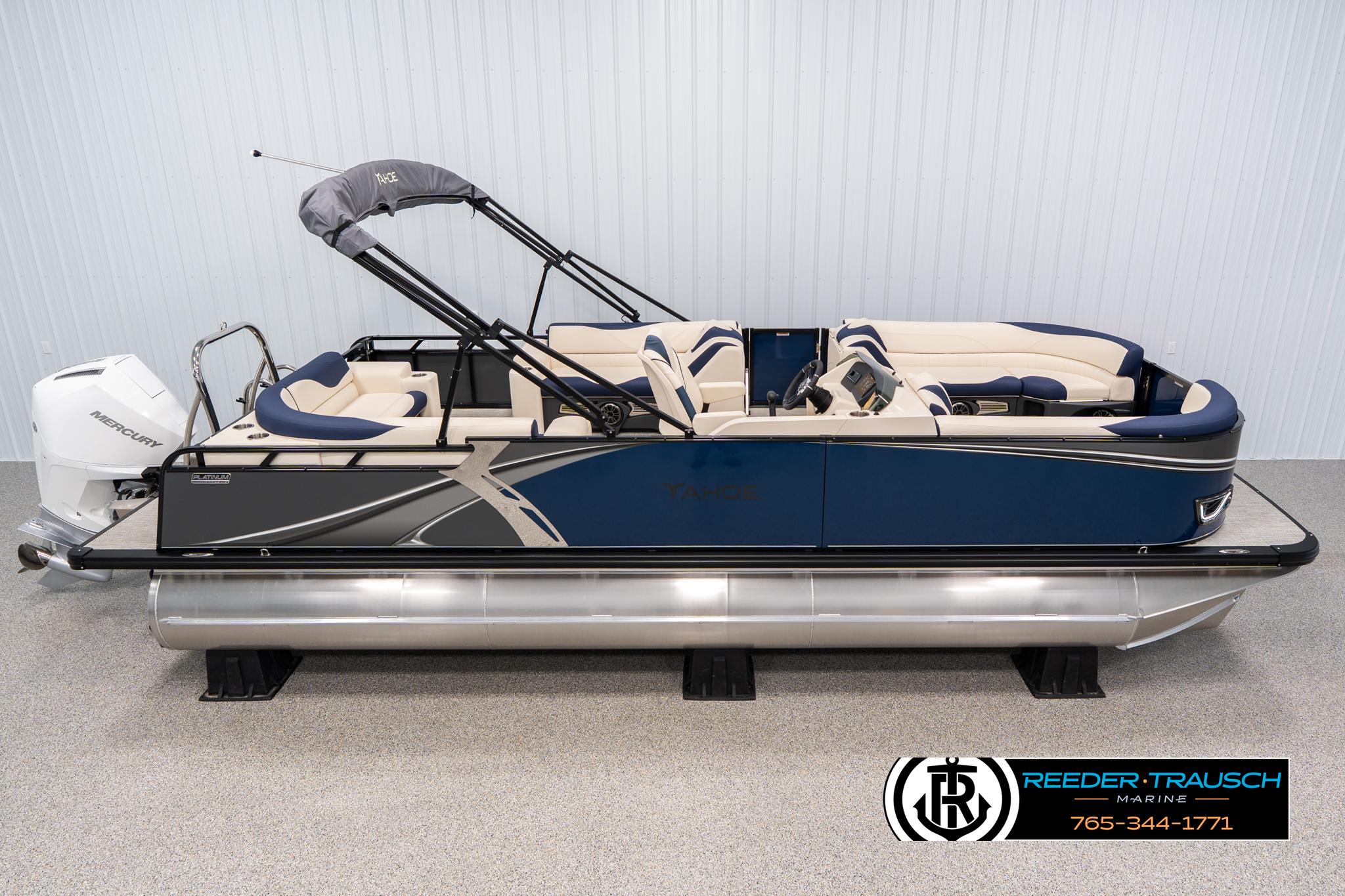 Tahoe LTZ EL 2025 Tahoe LTZ EL pontoon boat with blue and beige seating, displayed indoors.