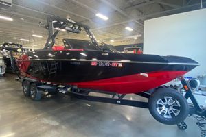 Axis A24 2019 Axis A24 boat in showroom, black and red design on trailer.
