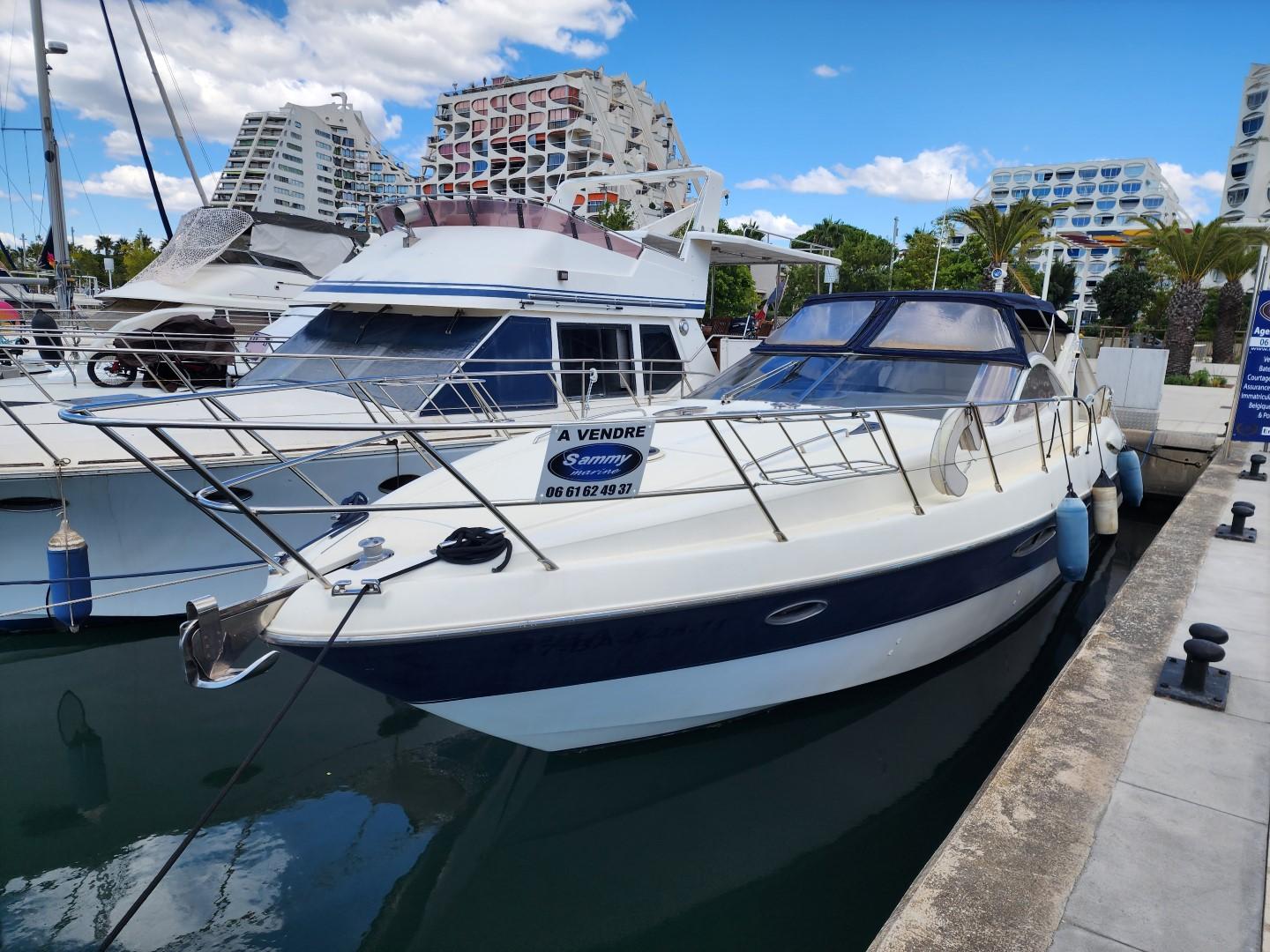 Gobbi Atlantis 47 2004 Gobbi Atlantis 47 yacht docked, for sale, with modern buildings in the background.