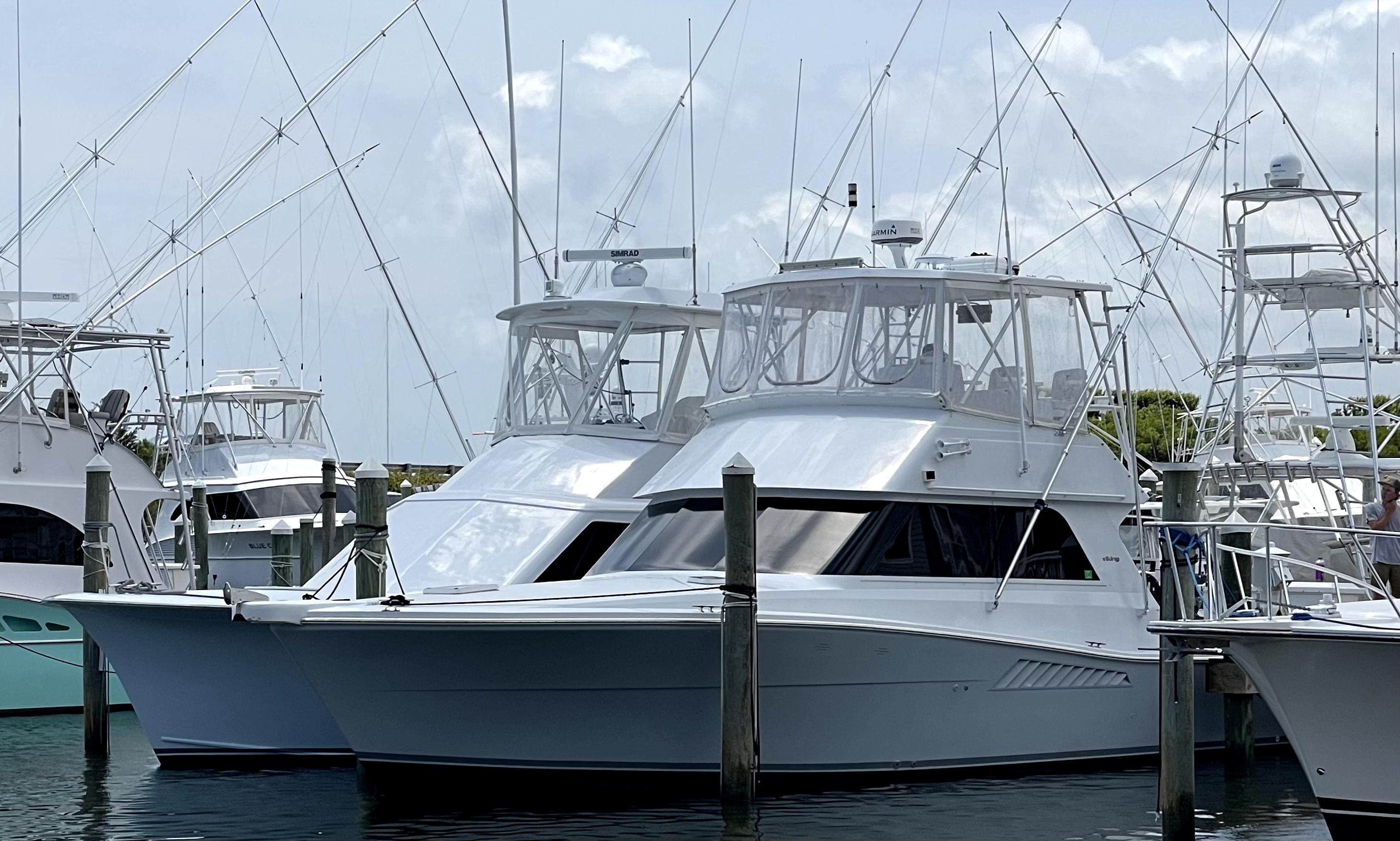 Viking 38 Convertible 1994 Viking 38 Convertible yacht docked at marina with fishing rods.