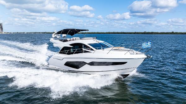 Sunseeker Manhattan 52 2021 Sunseeker Manhattan 52 yacht cruising on open water under a blue sky.