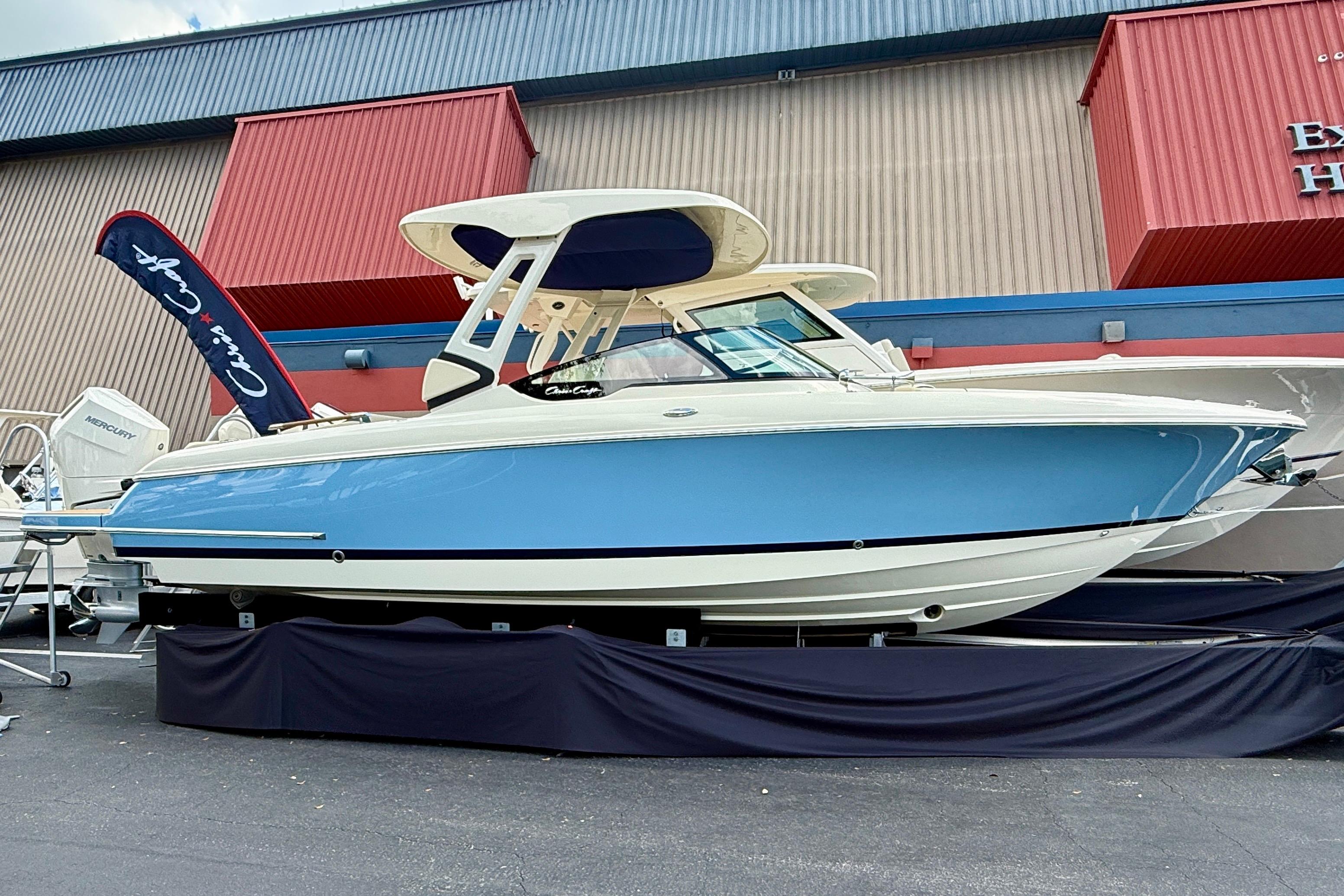 Chris-Craft Sportster 28 2026 Chris-Craft Sportster 28 boat displayed outdoors, featuring a sleek blue and white design.