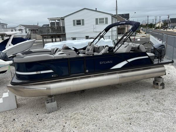 Sylvan L3 RLZ 2025 Sylvan L3 RLZ pontoon boat on dry dock, featuring sleek design and comfortable seating.