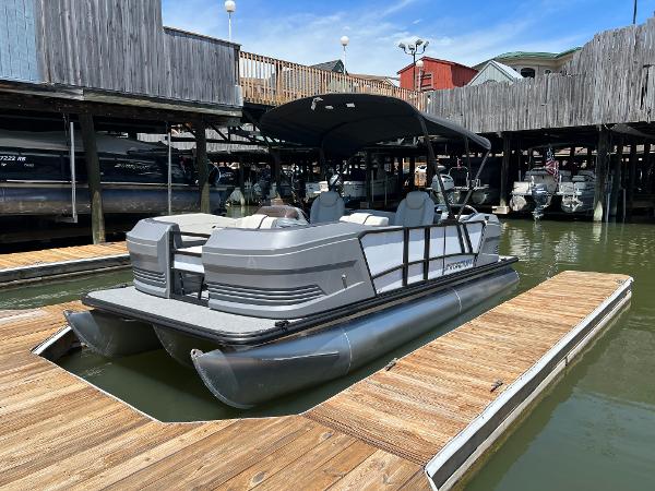 Starcraft GX 22 R DH Sport 2025 Starcraft GX 22 R DH Sport pontoon boat docked at a marina.