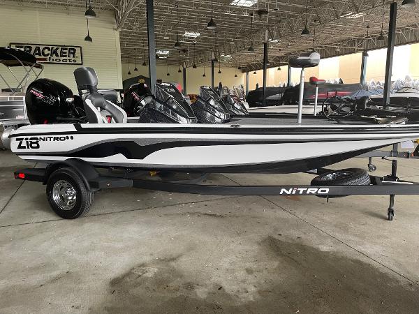 Nitro Z18 2025 Nitro Z18 boat in showroom, sleek design, black and white color scheme.