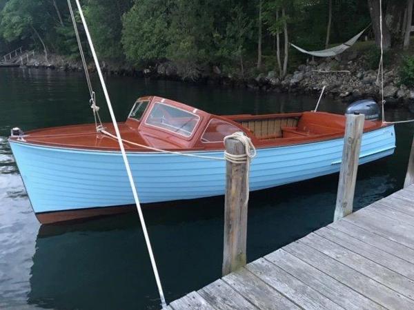 Lyman 18 Outboard 1956 Lyman 18 Outboard boat docked on a serene lake.