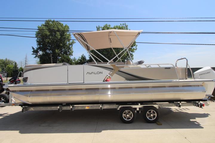 Avalon LSZ Versatile Rear Bench 2025 Avalon LSZ Versatile Rear Bench pontoon boat on trailer, parked outdoors.