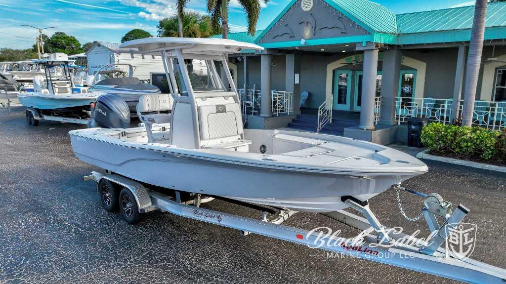 Sea Fox Seafox 251 Bay 2024 Sea Fox Seafox 251 Bay boat on a trailer outside a marine dealership.