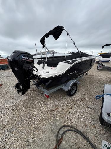 Bayliner Element M17 2023 Bayliner Element M17 boat with Mercury engine on a trailer, parked outdoors.