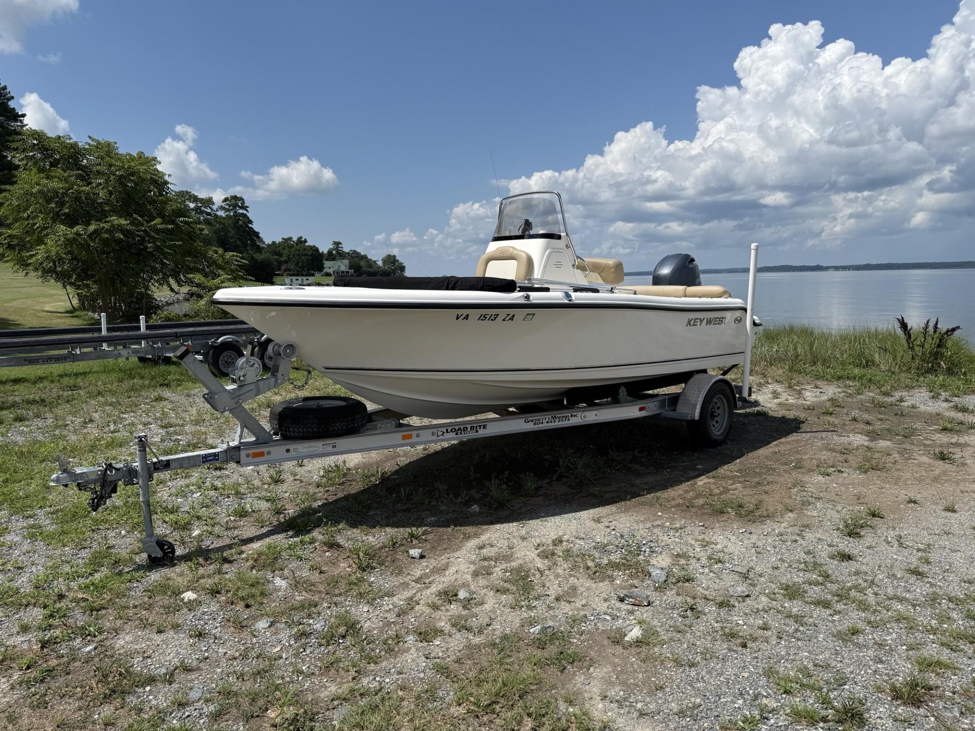 Key West 189 FS 2018 Key West 189 FS boat on trailer by a lake under a cloudy sky.