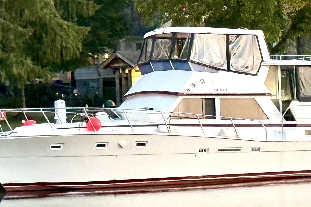 Viking 44 Motor Yacht 1987 Viking 44 Motor Yacht docked, surrounded by lush greenery.