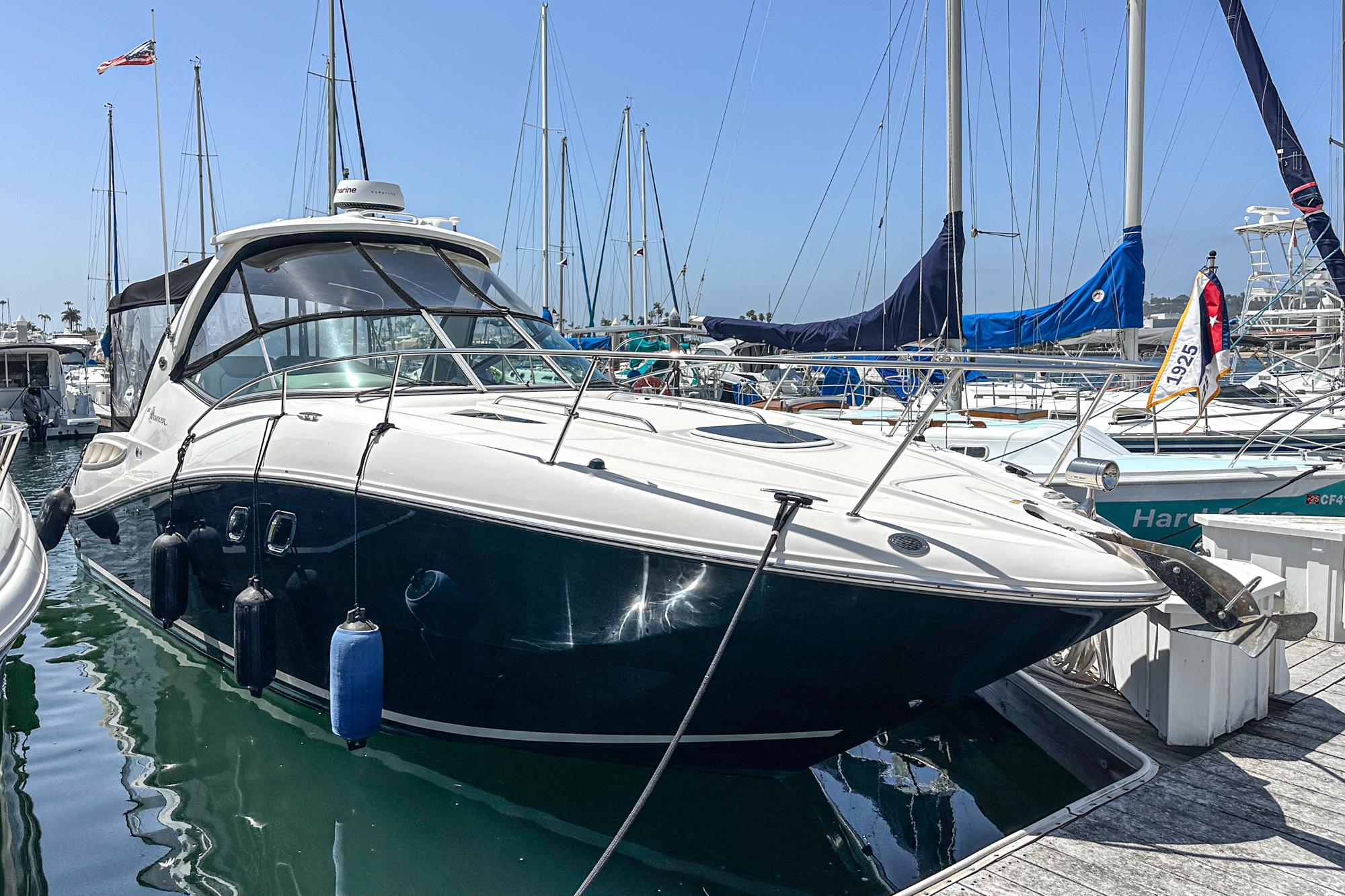 Sea Ray 310 Sundancer 2007 Sea Ray 310 Sundancer docked at marina, surrounded by sailboats.