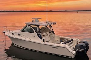 Pursuit OS 315 Offshore 2013 Pursuit OS 315 Offshore boat on calm water at sunset.