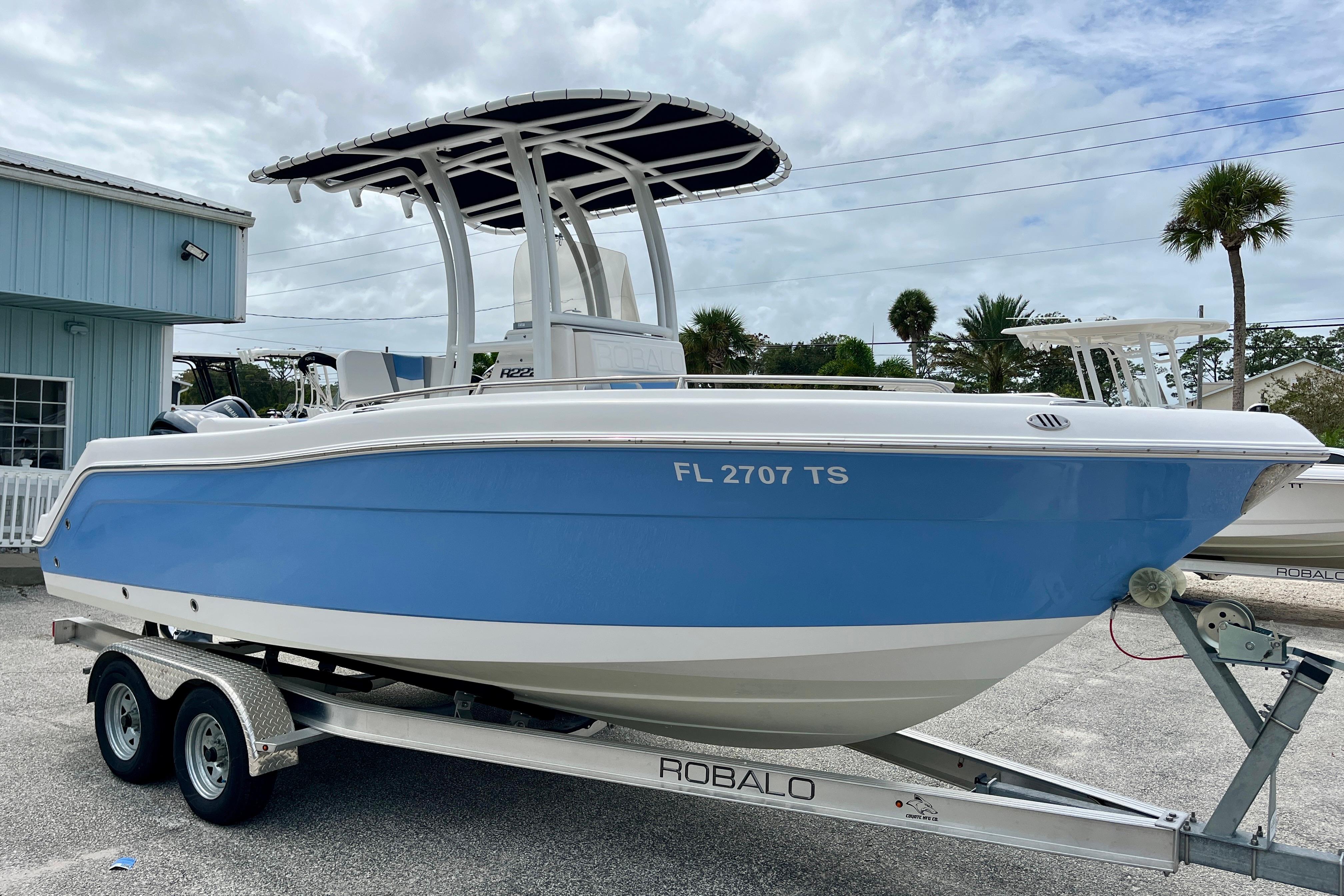 Robalo R222 Center Console 2024 Robalo R222 Center Console boat on trailer, blue hull, parked outdoors.