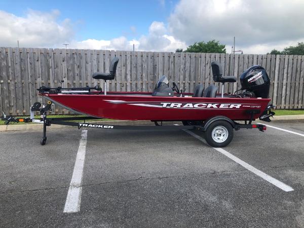 Tracker Pro 170 2025 Tracker Pro 170 boat in parking lot, red color, with trailer and outboard motor.