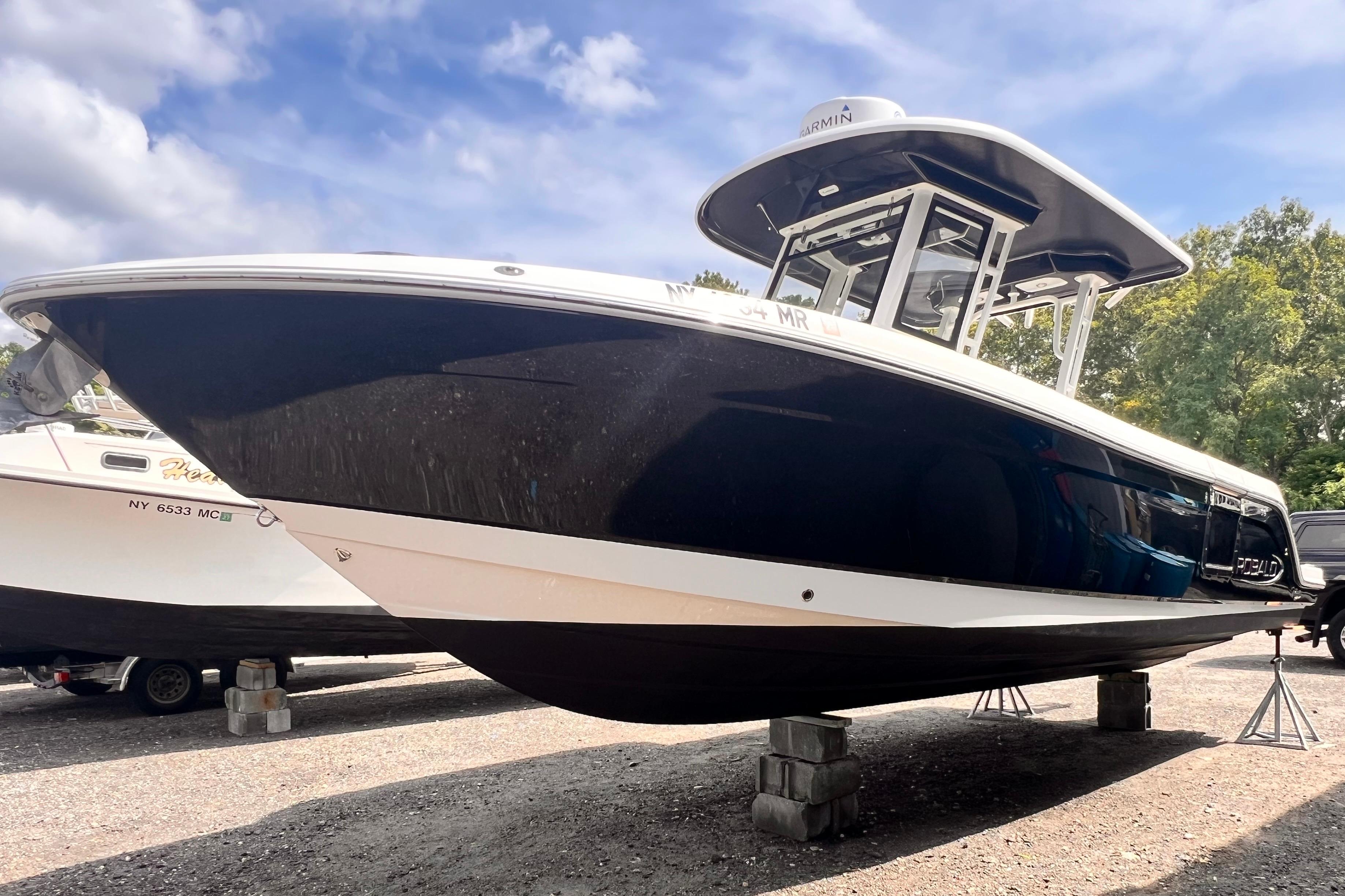 Robalo R272 Center Console 2020 Robalo R272 Center Console boat on stands, under a partly cloudy sky.
