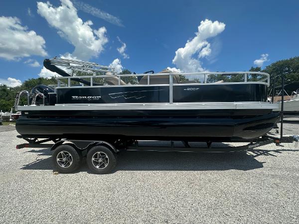 Ranger Reata 200F 2024 Ranger Reata 200F pontoon boat on a double-axle trailer under a clear blue sky.