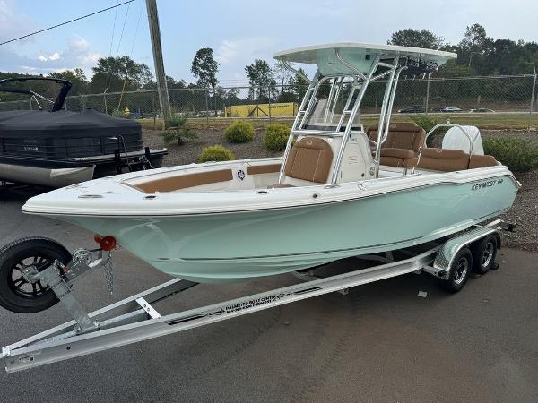 Key West 239FS 2025 Key West 239FS boat on trailer, light blue hull, parked outdoors.