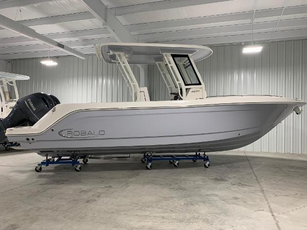 Robalo R270 Center Console 2026 Robalo R270 boat in a showroom, side view, on stands.