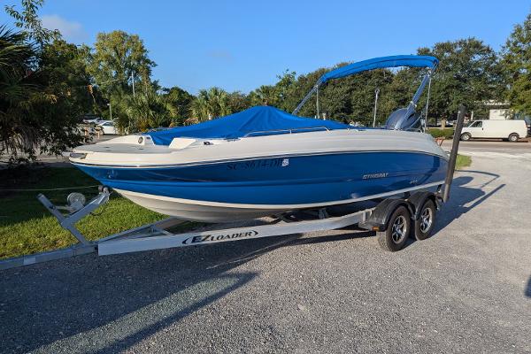 Stingray 192 SC 2021 Stingray 192 SC boat on trailer, blue and white, parked outdoors.
