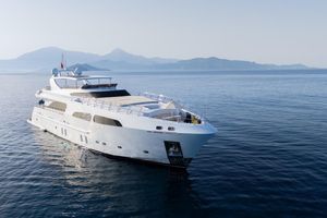 Dragos Custom Luxurious 2012 Dragos yacht cruising on calm sea with scenic mountain backdrop.