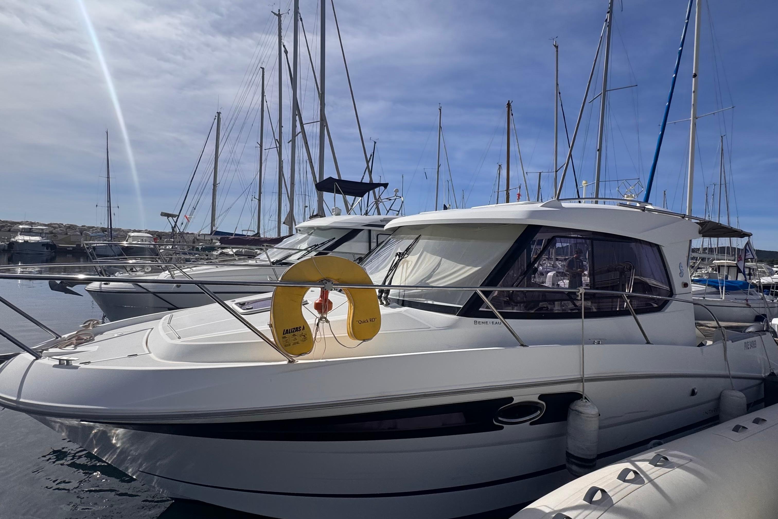Beneteau Antares 8.80 2013 Beneteau Antares 8.80 boat docked in marina under clear sky.